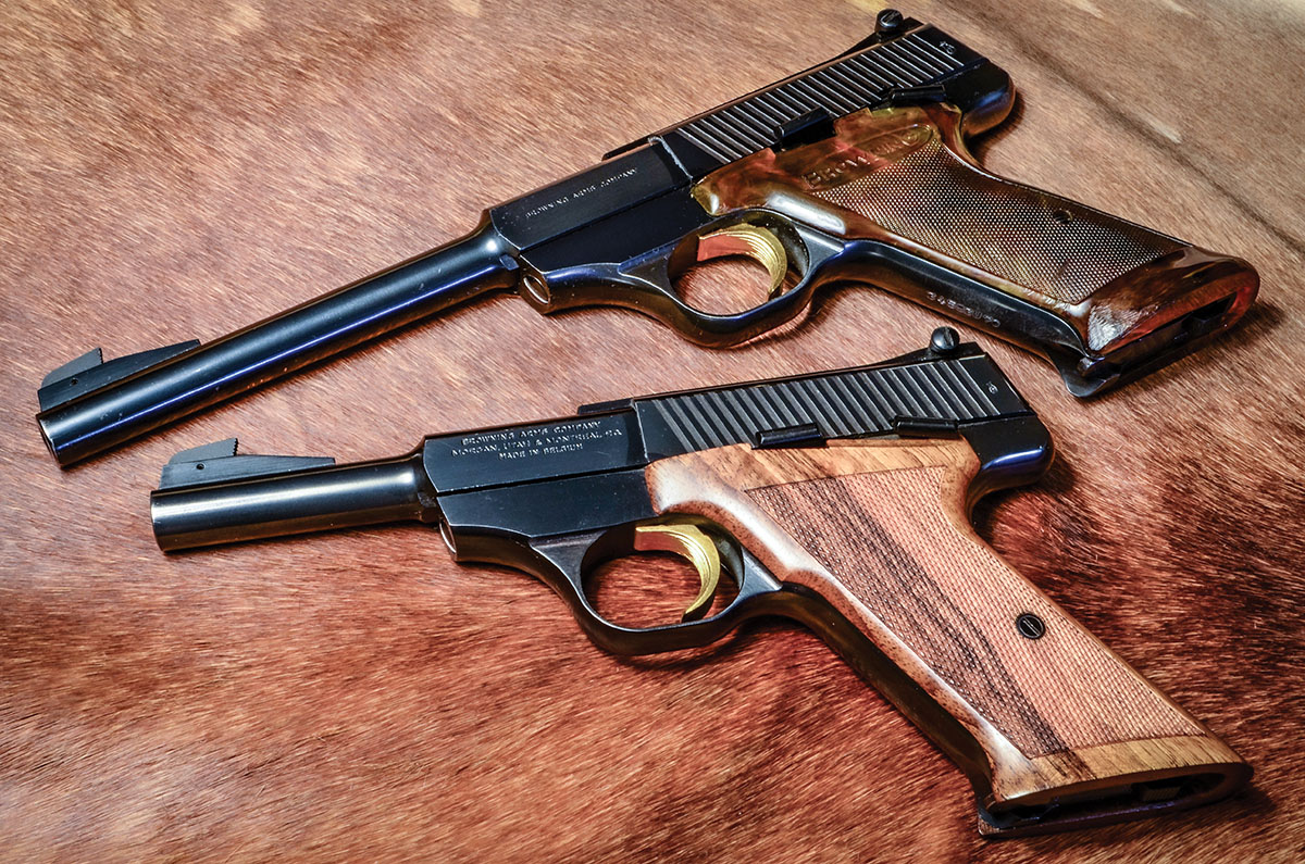Two iterations of the Browning Challenger, with the 4.5-inch barrel and 6.75-inch barrel: the later amber-colored Novadura grip (top) and an original walnut grip reshaped and reworked to fit a smaller hand (bottom).
